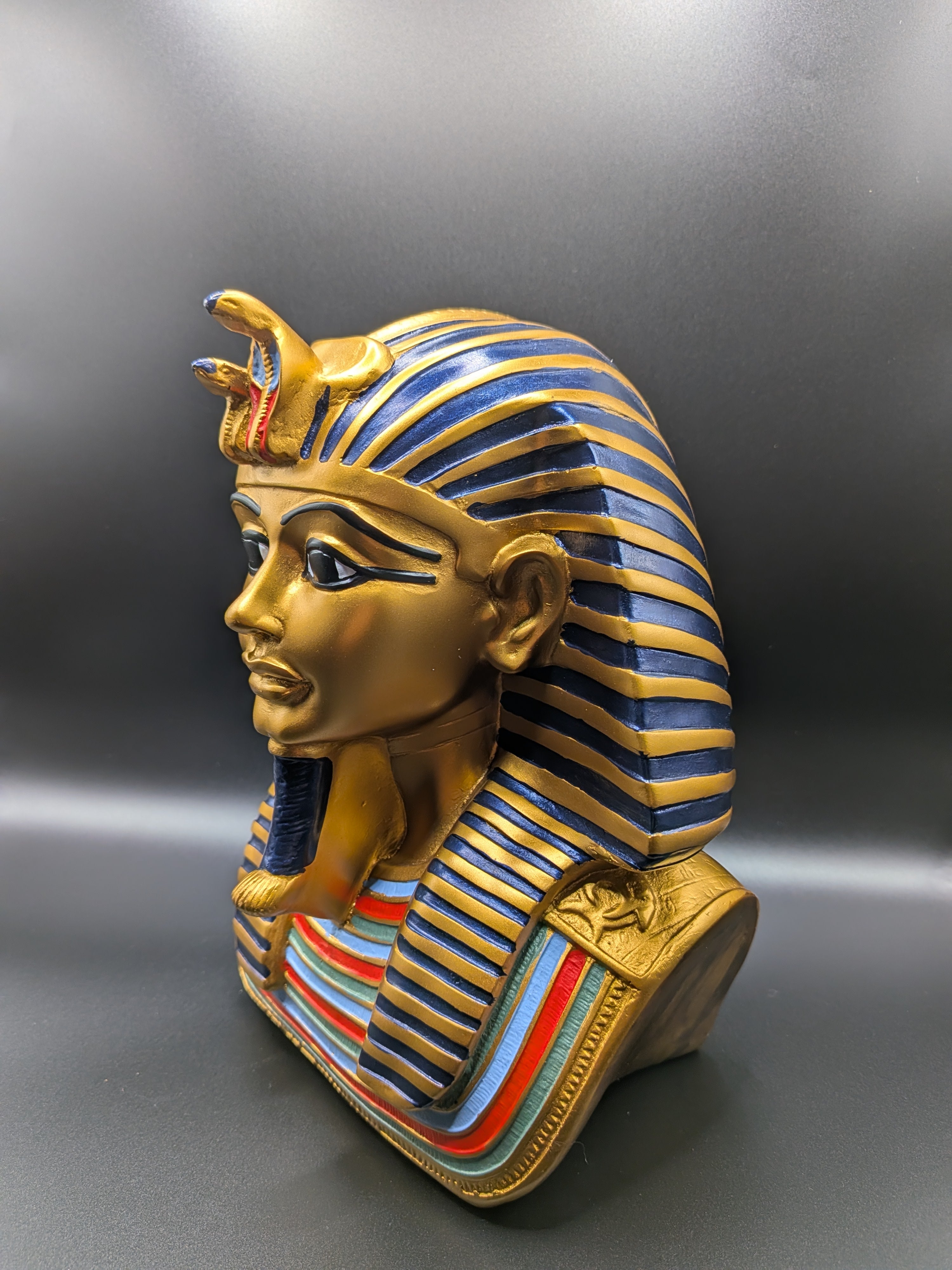 Decorative wall mask with Egyptian pharaoh design on a gray background